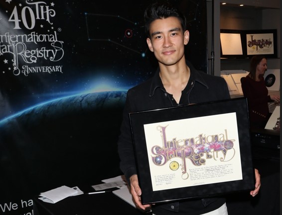 Alex Landi holding his name a star certificate from starregistry.com