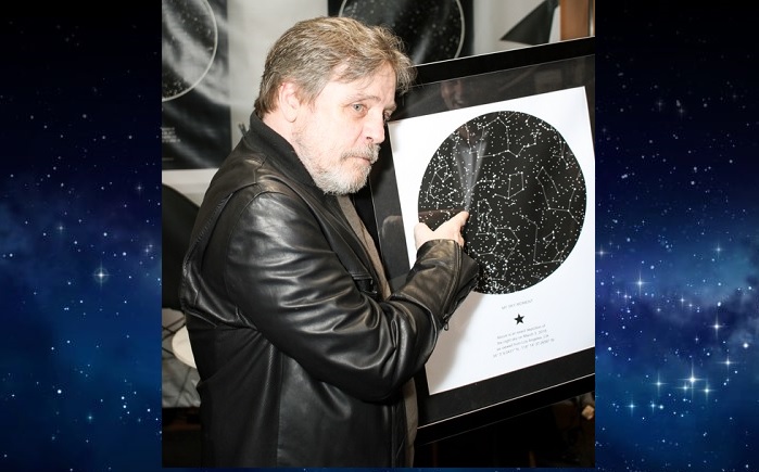 Mark Hamill holding a sky map from International Star Registry