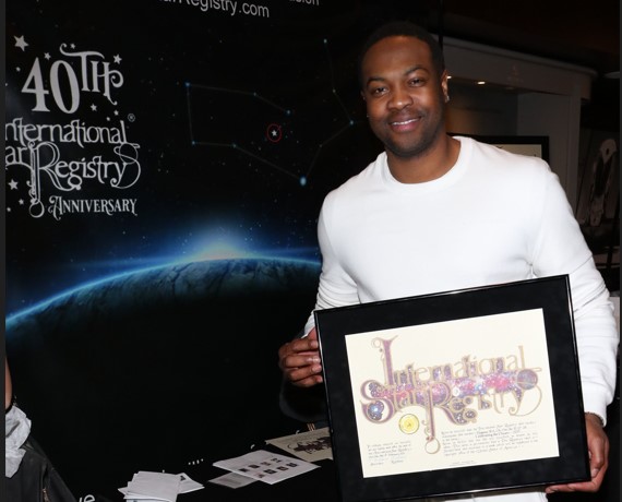 Ser'Darius Blain holding his name a star certificate from starregistry.com