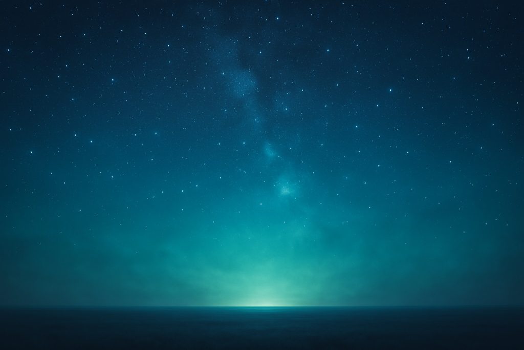A view looking toward a light on the horizon. Above is a sky filled with stars