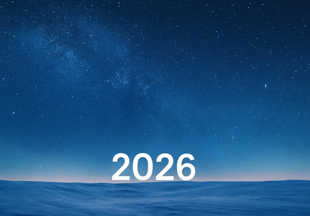 The Year 2026 glows on the horizon as we welcom the new year. In the below there is a field of snow and behind it is a starry night sky.