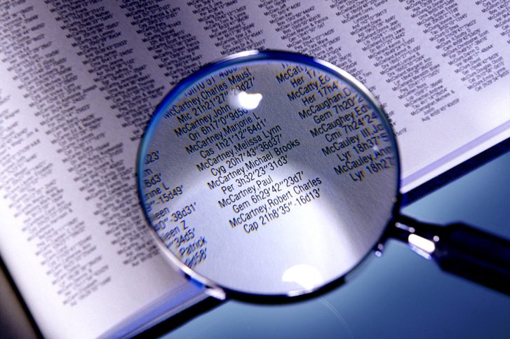 Magnifying glass shows star names in Book Your Place in the Cosmos